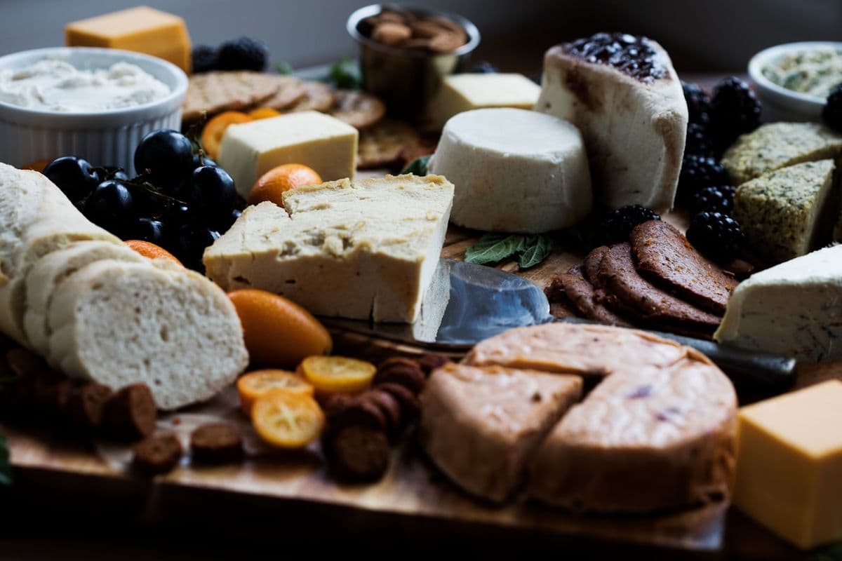 Cheese board with bread, grapes and nuts